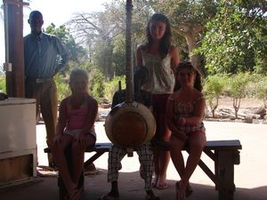 Litty, Ellen, & Isobel posing with a boy playing a kora