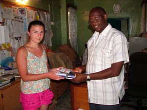 Handing over some pencils & pens to the head teacher.